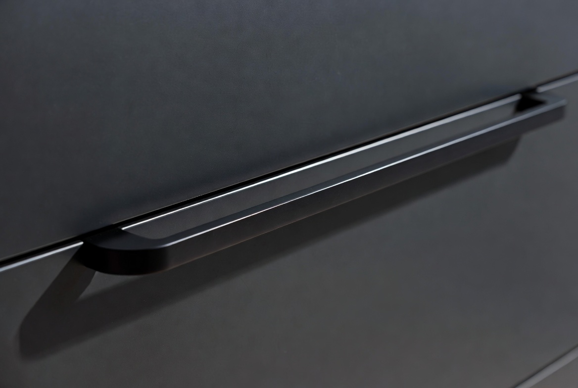 Matte black handle detail on a sleek sliding wardrobe door